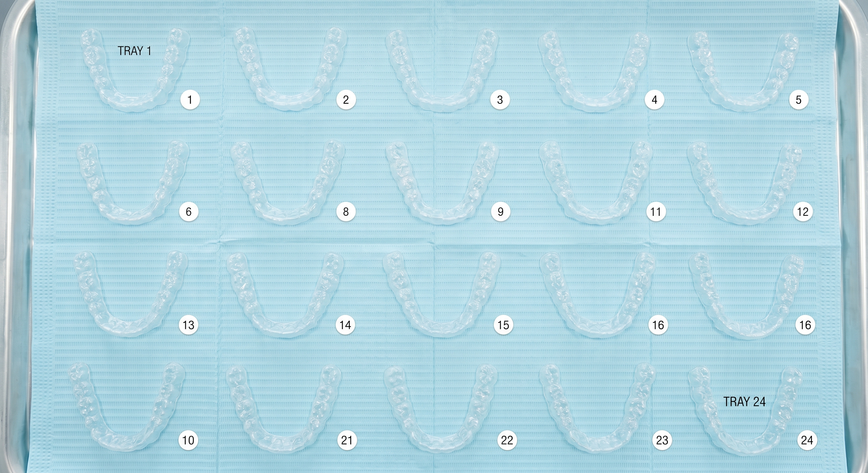 Full set of numbered Invisalign clear aligner trays showing a complete treatment timeline